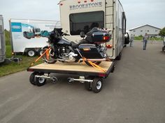 a motorcycle is on the back of a trailer