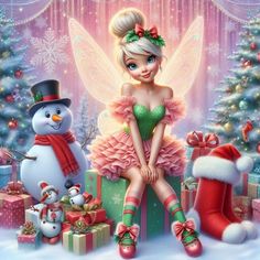 a christmas fairy sitting on top of a gift box next to a snowman