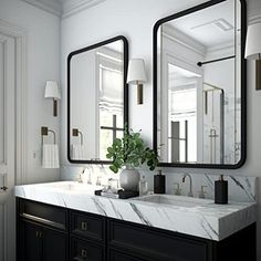 a bathroom with two sinks and mirrors on the wall