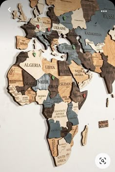 the world map is made out of wooden pieces