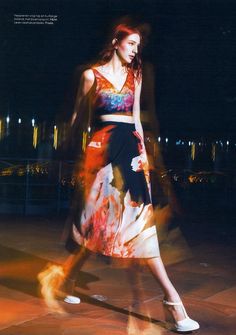 a woman in a colorful dress is walking