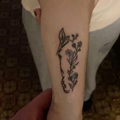 a person with a flower tattoo on their arm