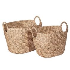 two woven baskets sitting next to each other on a white background, one is empty and the other has round handles