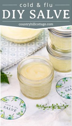 two jars filled with cream sitting on top of a table