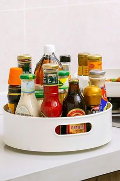 an assortment of condiments in a white container