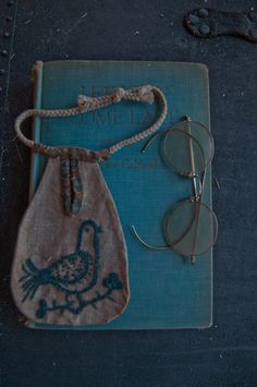 a pair of glasses sitting on top of a book