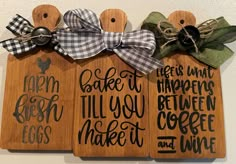 three wooden plaques with different sayings on them hanging from the side of a wall