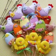 a bunch of little chicks sitting next to each other on top of a table with flowers