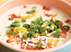 a bowl filled with soup and vegetables on top of a table