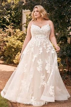 a woman in a wedding dress standing outside