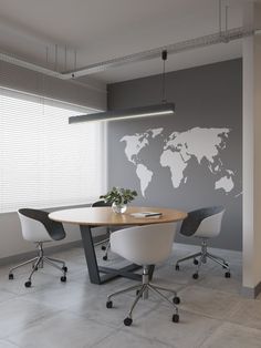 an office with a table, chairs and a world map on the wall