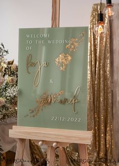 a welcome sign for the bride and groom to be placed on an easel in front of gold sequins