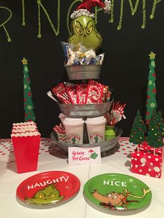 a table topped with plates and cups filled with candy