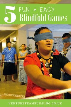 a woman with blindfolds on her eyes is holding a tennis racquet