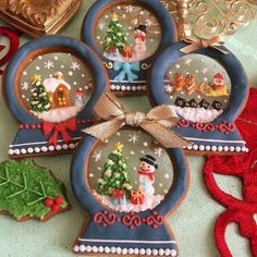 four snow globes decorated with christmas decorations