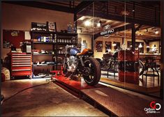 a motorcycle is on display in a shop with many other items behind the glass doors