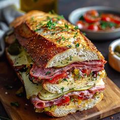 a ham and cheese sandwich cut in half on a cutting board