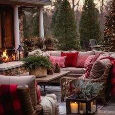 an outdoor living area with couches, tables and christmas decorations on the outside patio