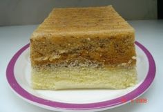 a piece of cake sitting on top of a white and purple plate with pink trim