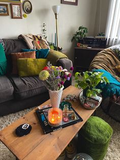 a living room filled with lots of furniture and flowers on top of a coffee table