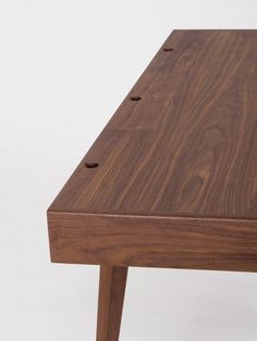 a wooden table with three holes in the middle and one hole on the side that is missing