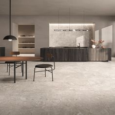 a modern kitchen and dining room with white tile flooring, wooden table and chairs