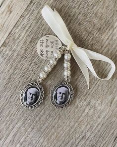 a pair of earrings with a photo on them