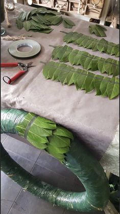 the table is covered with green leaves and other things to make it look like they have fallen