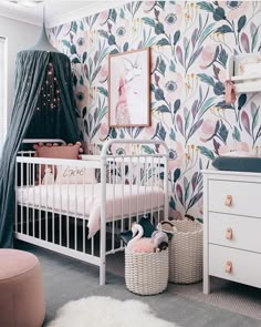 a baby's room with floral wallpaper and white crib in the corner