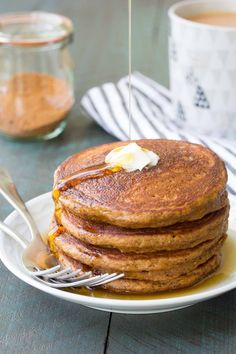 a stack of pancakes with butter and syrup