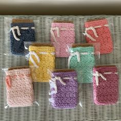 small crocheted items are wrapped in plastic on a wicker tablecloth holder