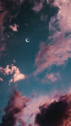 the moon is shining brightly in the sky above some clouds and pinkish purple hues