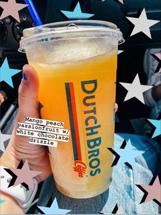 a person holding a drink in their hand with stars on the ground behind it and text that reads dutch bros