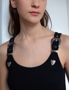 FINAL SALE Black ribbed tank top with decorative western belt shoulder straps . Brand Pixie Market98% cotton, 2% elastaneRuns true to sizeModel is wearing size smallLength 21"Dry clean onlyImported Western Style Accessories, Western Rocker Aesthetic, Alternative Western Aesthetic, Two Belts Outfit, Bella Hadid Western, Western Club Outfit, Folk Punk Fashion, Western Granola Outfits, Goth Cowgirl Aesthetic