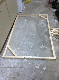 an unfinished frame is sitting on the floor