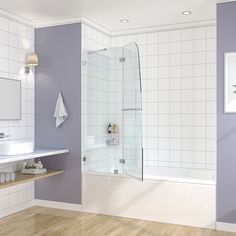 a bathroom with white and purple walls, wood flooring and a glass shower door