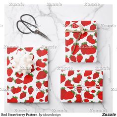 red strawberries pattern with white bow and scissors on marble background for wrapping paper or gift wrap