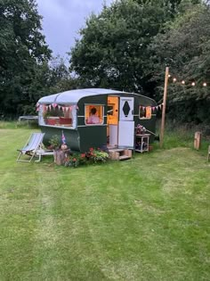 a trailer parked on top of a lush green field