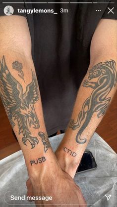 two people with tattoos on their arms holding hands