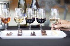 several glasses of wine are sitting on a tray