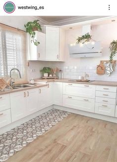 the kitchen is clean and ready for us to use it's white cabinetry