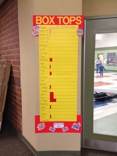 a box top sign in front of a door with the words box tops on it