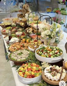 a buffet table filled with lots of different types of foods and desserts on it