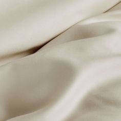 the white sheets are folded together on top of each other in this close up photo