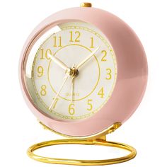 a pink and gold alarm clock on a stand