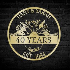 the logo for dany & sarah 40 years and established in gold on a black brick wall