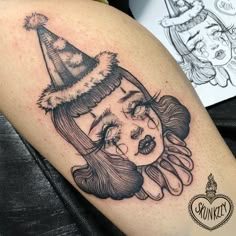 a woman's face with a santa hat on her head and an octopus tattoo