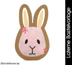 a brown and pink bunny face cut out from cardboard