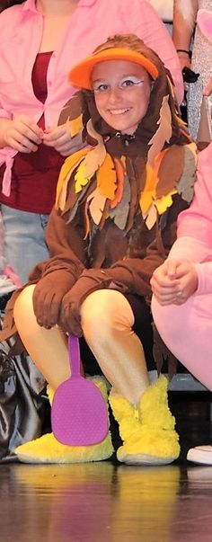 two children in costumes sitting on the floor