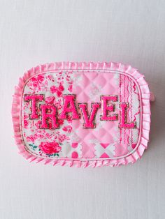 a pink tray with the word travel written on it